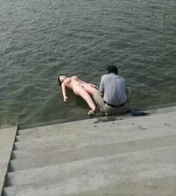 男子河边当众给充气娃娃洗澡(图片)